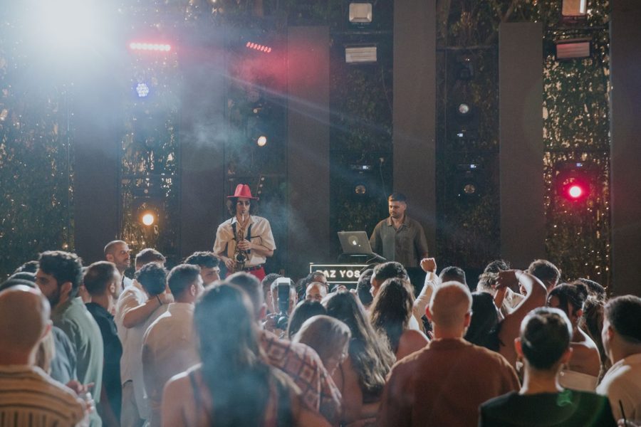 An audience in front of a lit stage at an event