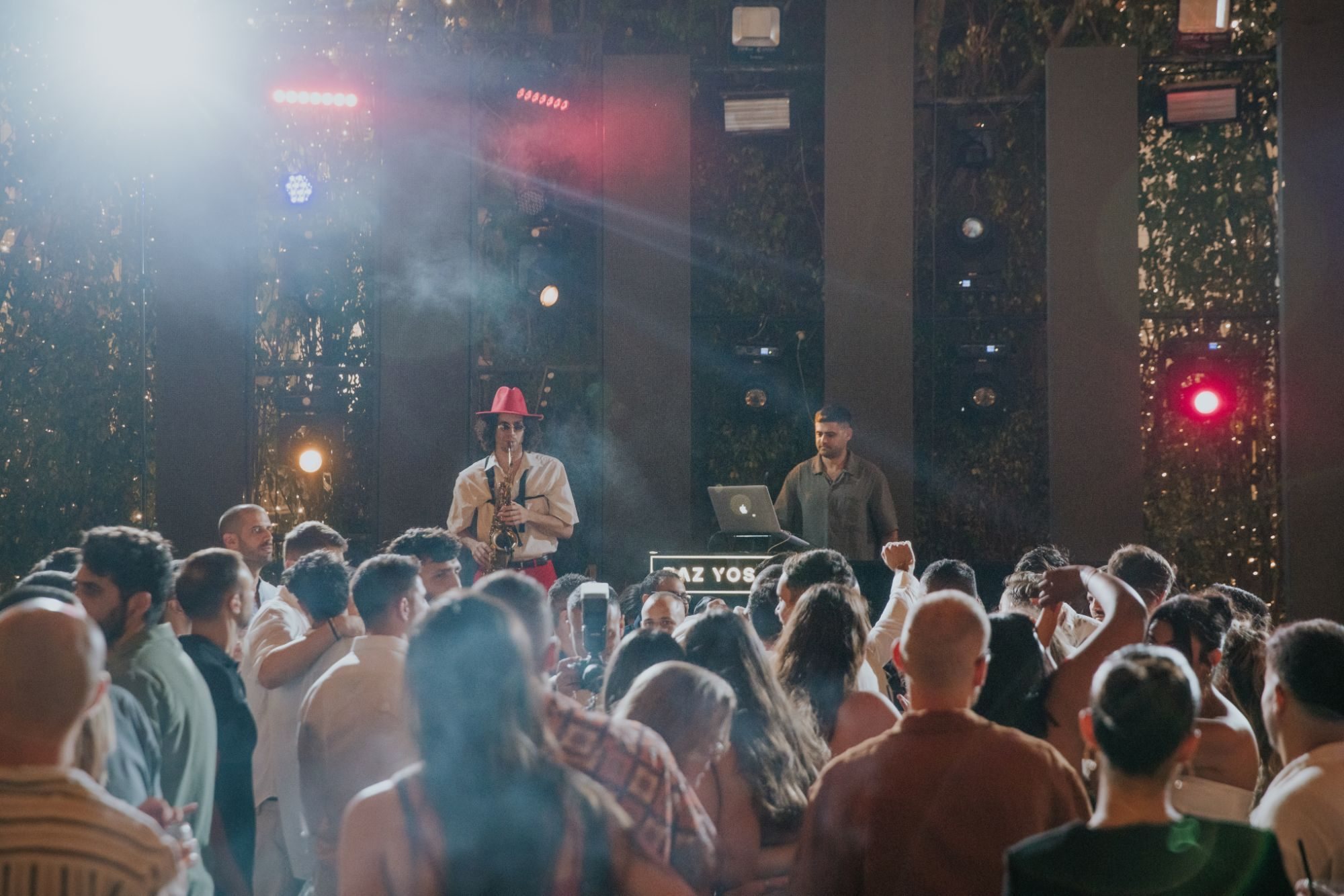 An audience in front of a lit stage at an event