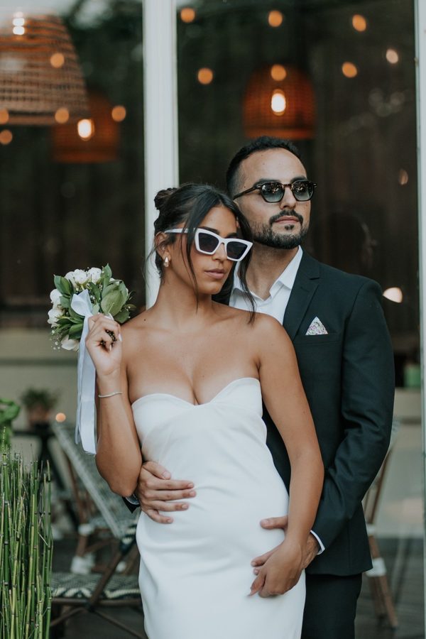 A couple posing together on their wedding day